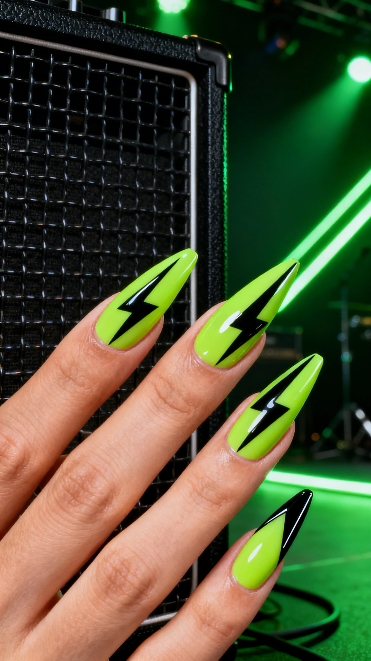 A striking macro of one hand with medium-long almond or stiletto nails in Hyperlime Lightning with Blackout Accents. Full-coverage hyperlime neon gel base. Middle and ring nails feature bold black lightning bolts starting at the cuticle and striking toward the free edge, tapering to a razor point. Index and pinky show diagonal black tip panels with crisp edges. Ultra-glossy topcoat for high contrast. Background: concert stage vibes—black metal grid or amp cabinet with neon green light streaks. High-res, sharp focus on nails, no faces.